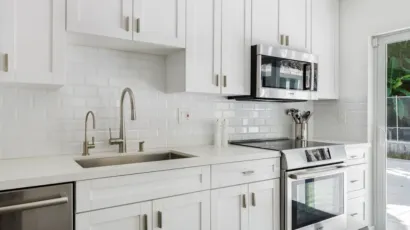 Kitchen remodeling project showing new cabinets, countertops, flooring and lighting during installation