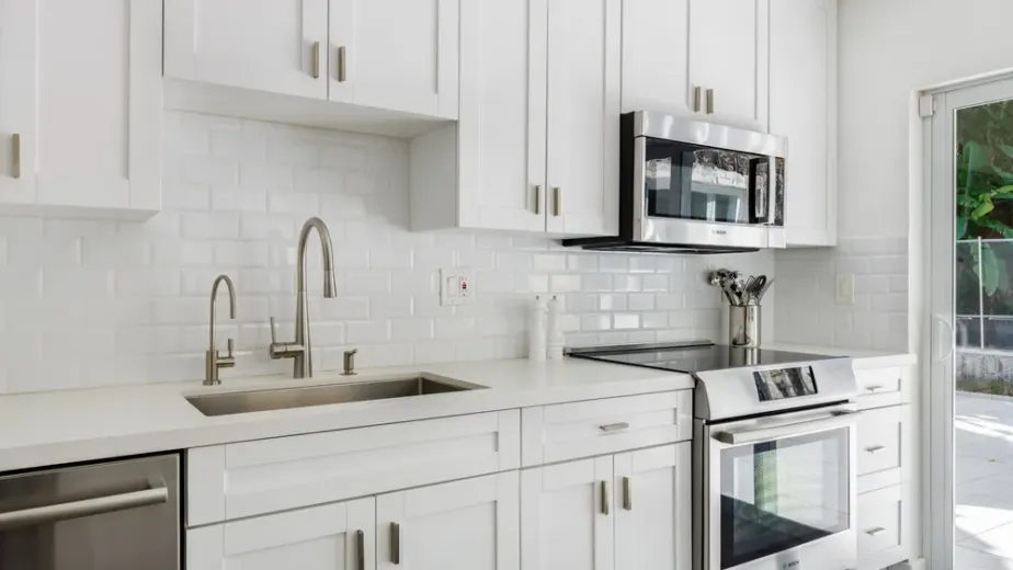 Kitchen remodeling project showing new cabinets, countertops, flooring and lighting during installation