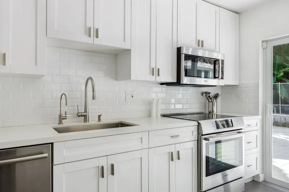Kitchen remodeling project showing new cabinets, countertops, flooring and lighting during installation