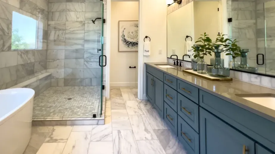 Modern mid-range bathroom remodel with walk-in shower, vanity, tile flooring and updated lighting