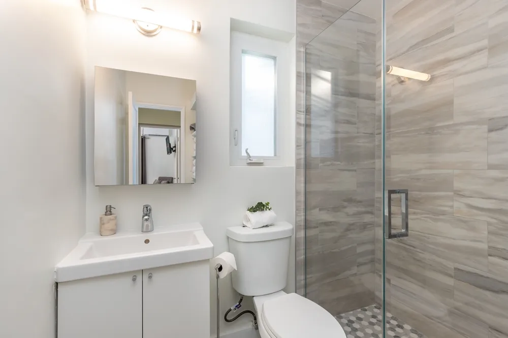 Bathroom remodel permit plans beside plumbing, electrical and tile installation work