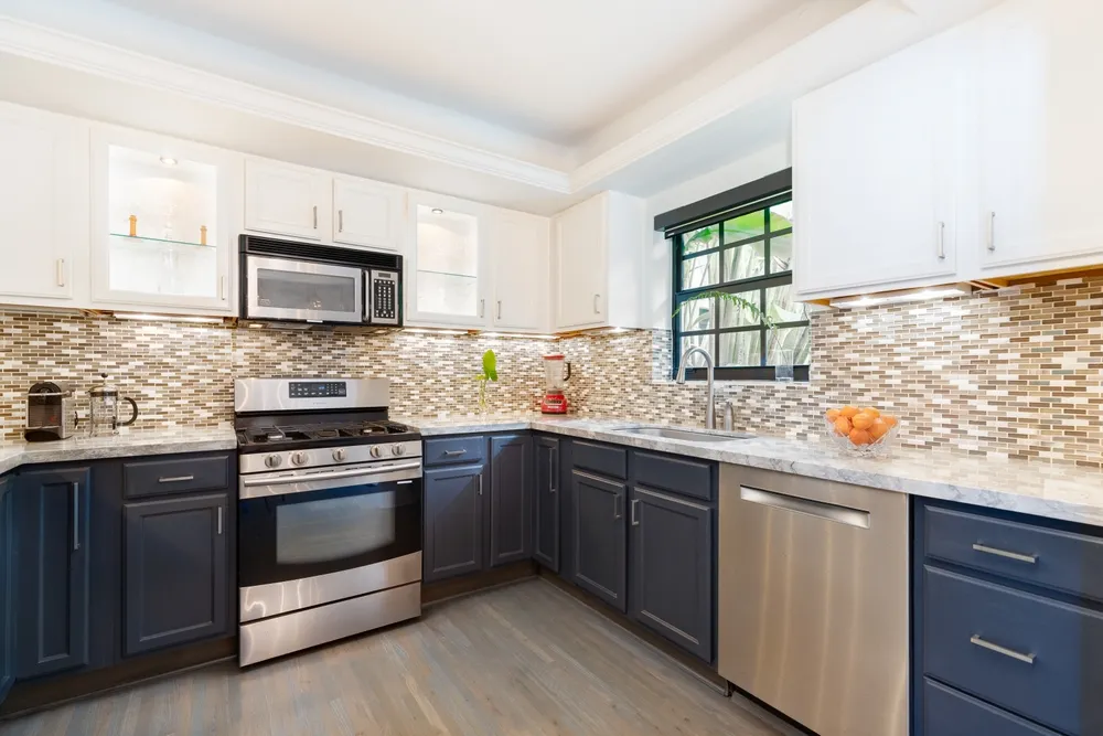 Remodeled Orange County kitchen with new cabinets, countertops, flooring, appliances and island lighting