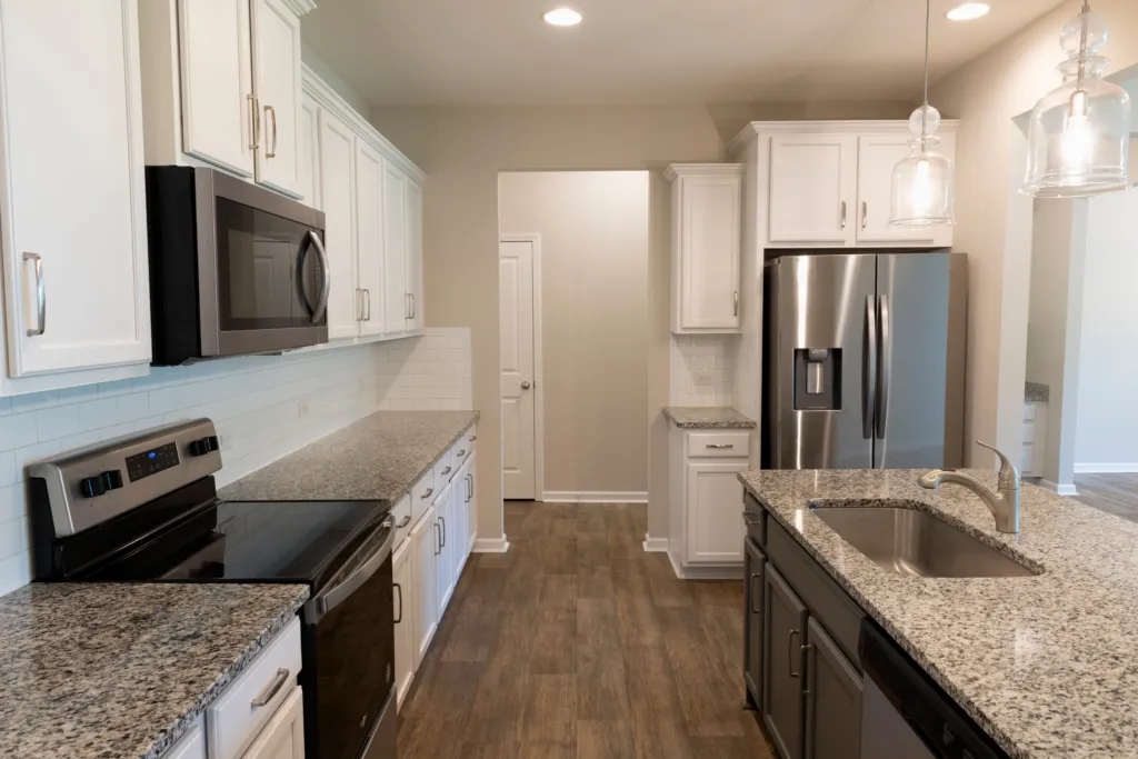 Remodeled Orange County kitchen with new cabinets, countertops, flooring, appliances and island lighting
